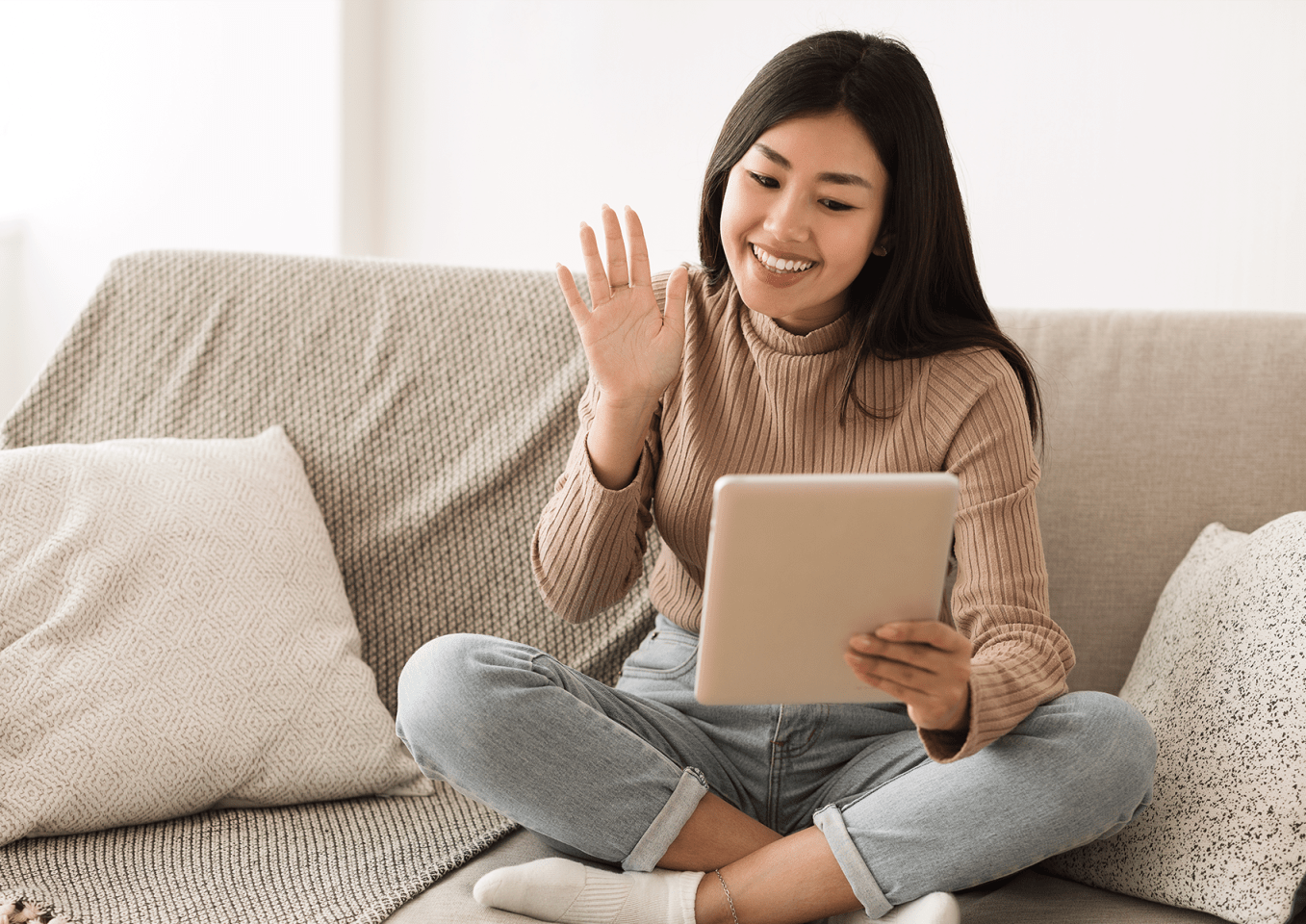 Woman on sofa networking virtually