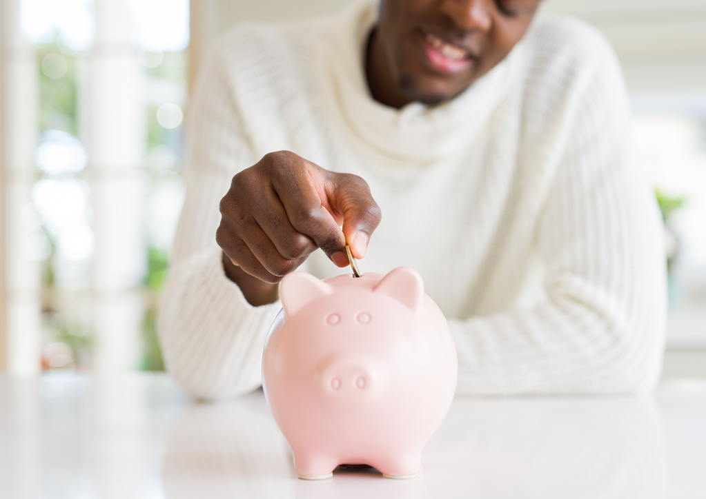 Man with piggy bang re-evaluating his prices