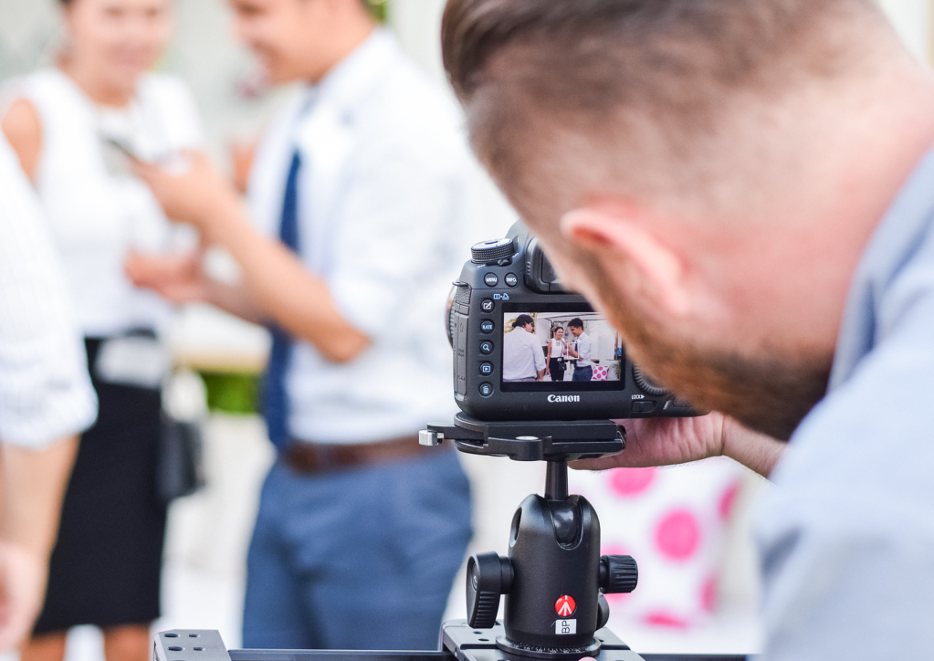 man with camera taking a photo of wedding guests