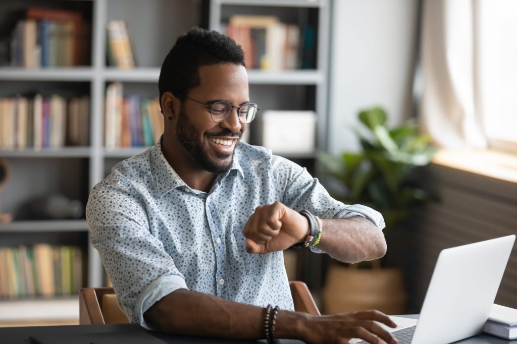 man checking his watch setting boundaries at work