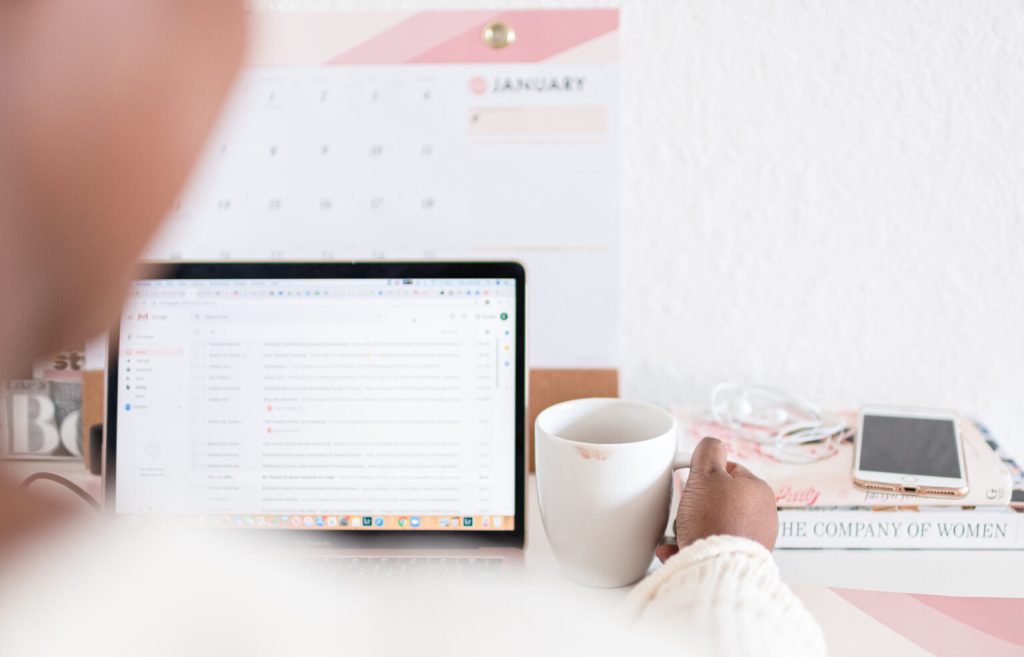 Woman checking lead replies on laptop