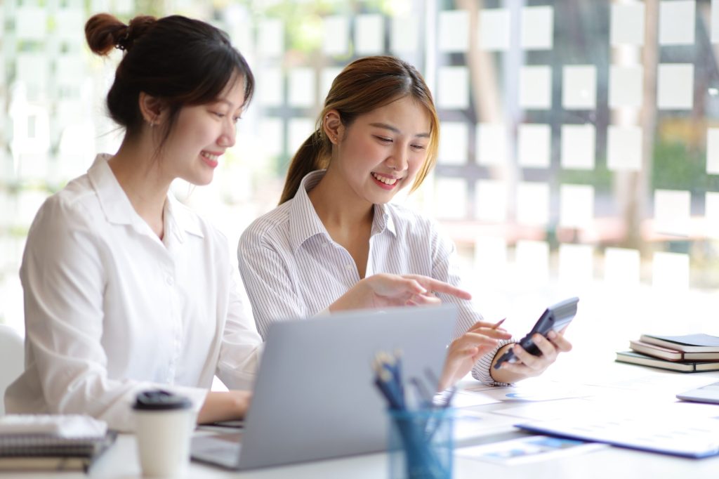 two woman discussing pricing and price increases