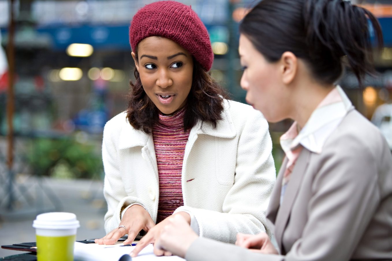 Two women discussing buy-in