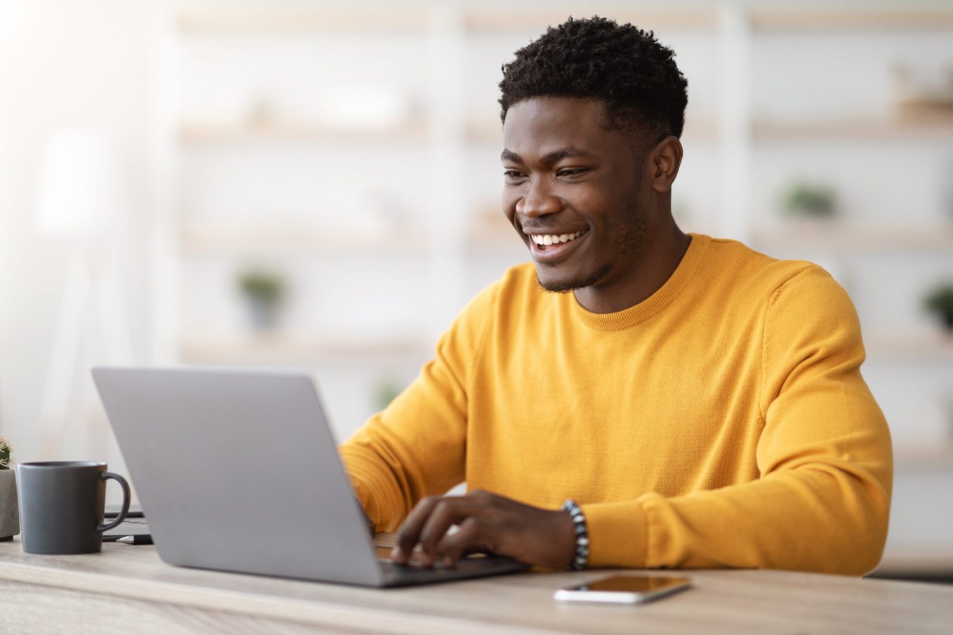 Man in yellow shirt sending out of office message