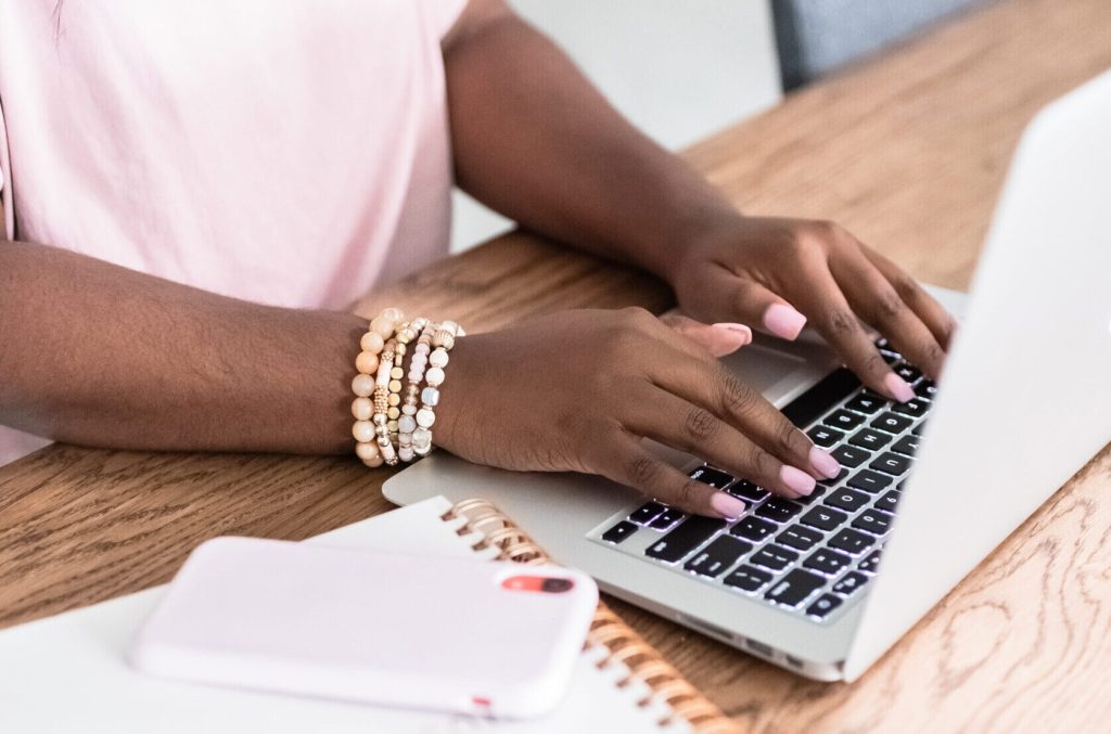 woman on laptop managing storefronts metrics