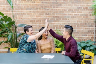 wedding vendor pricing strategy storefronts - a couple high fives their wedding vendor after agreeing to their pricing