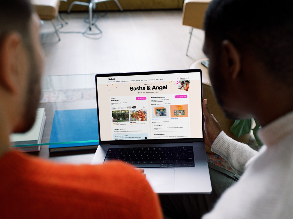 A male couple looking at their wedding website