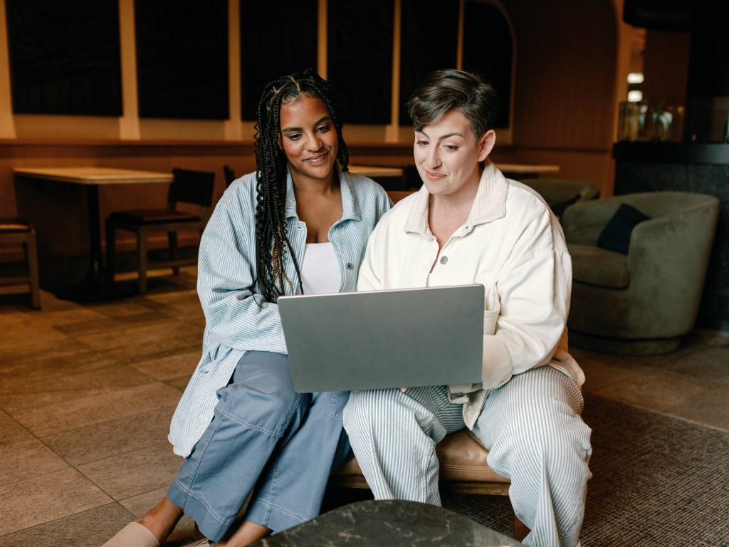 Two women looking at a laptop