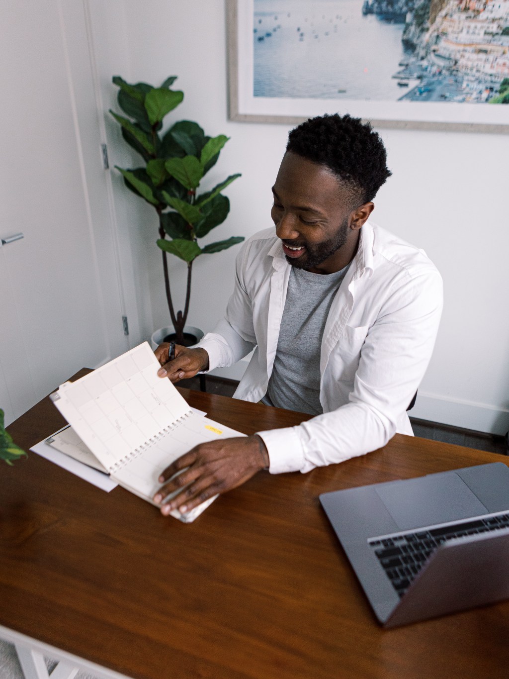 Man doing paper work with a computer