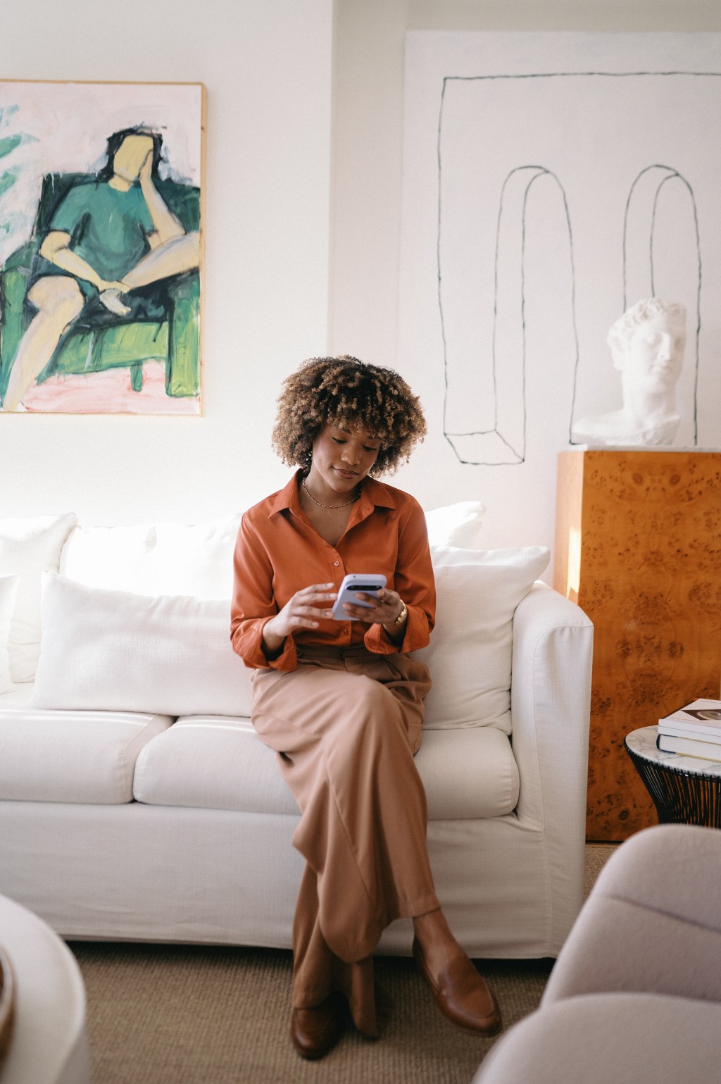 Woman sitting on couch on phone