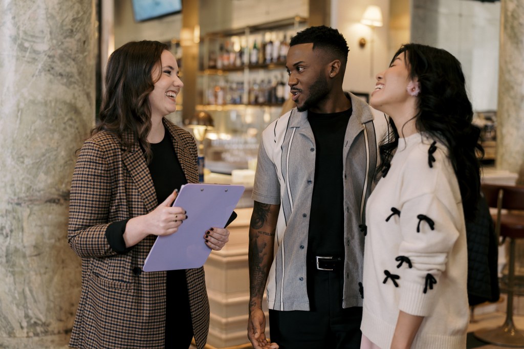 Women smiling and talking to couple