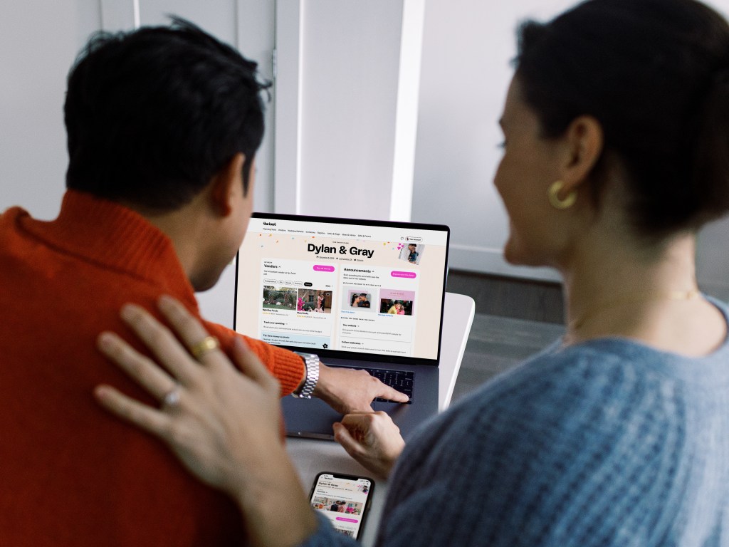 Couple looking at their The Knot wedding site
