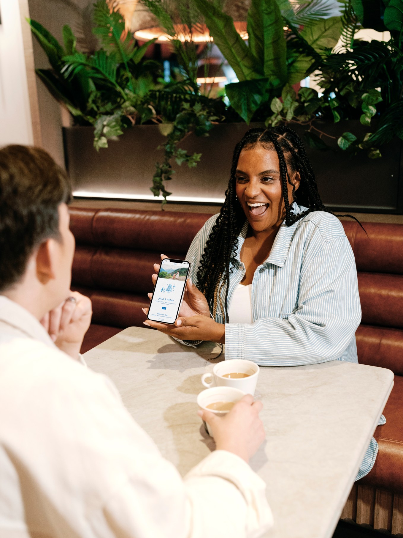 Diverse couple showing phone