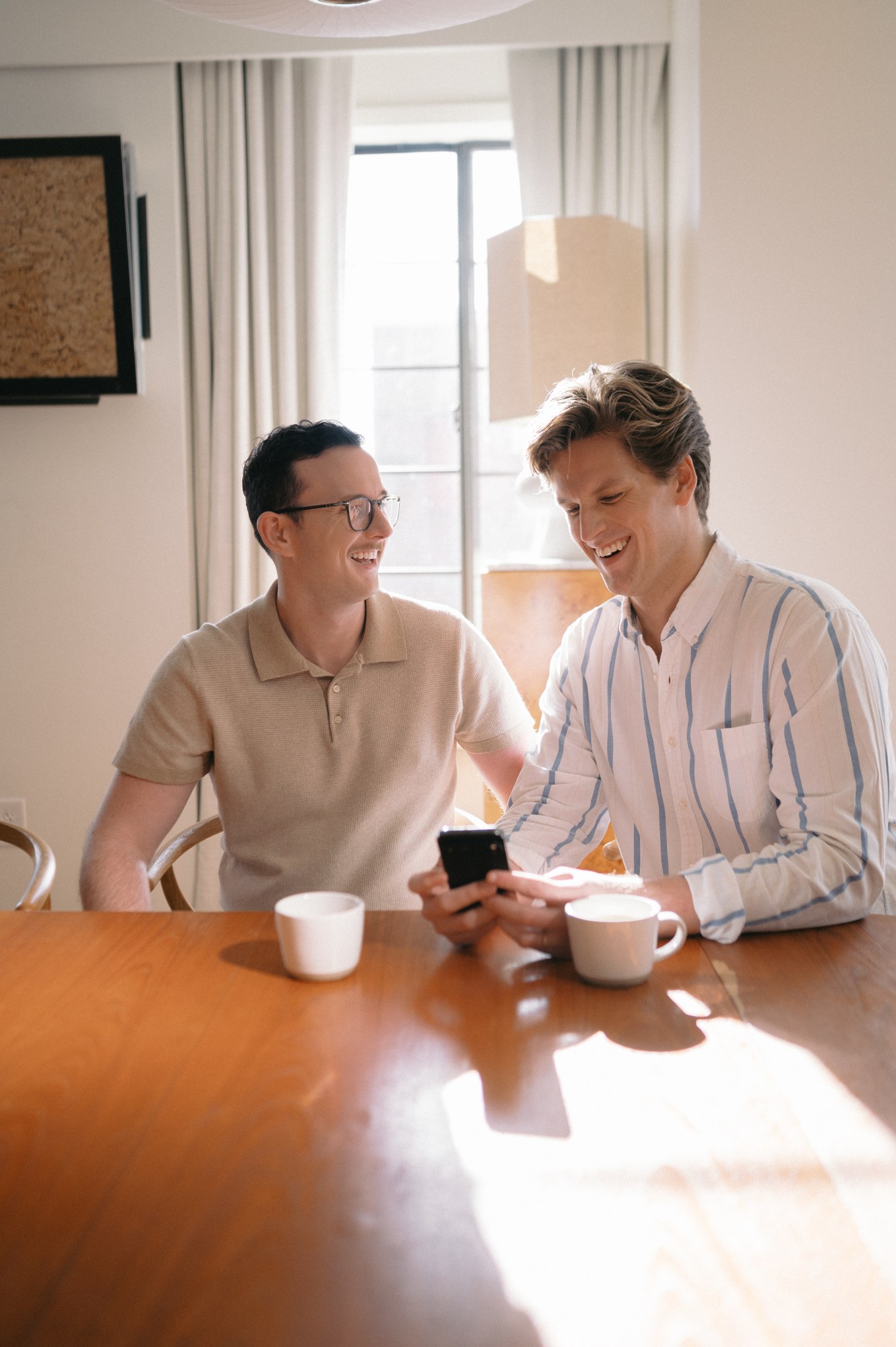 Happy male couple on phone